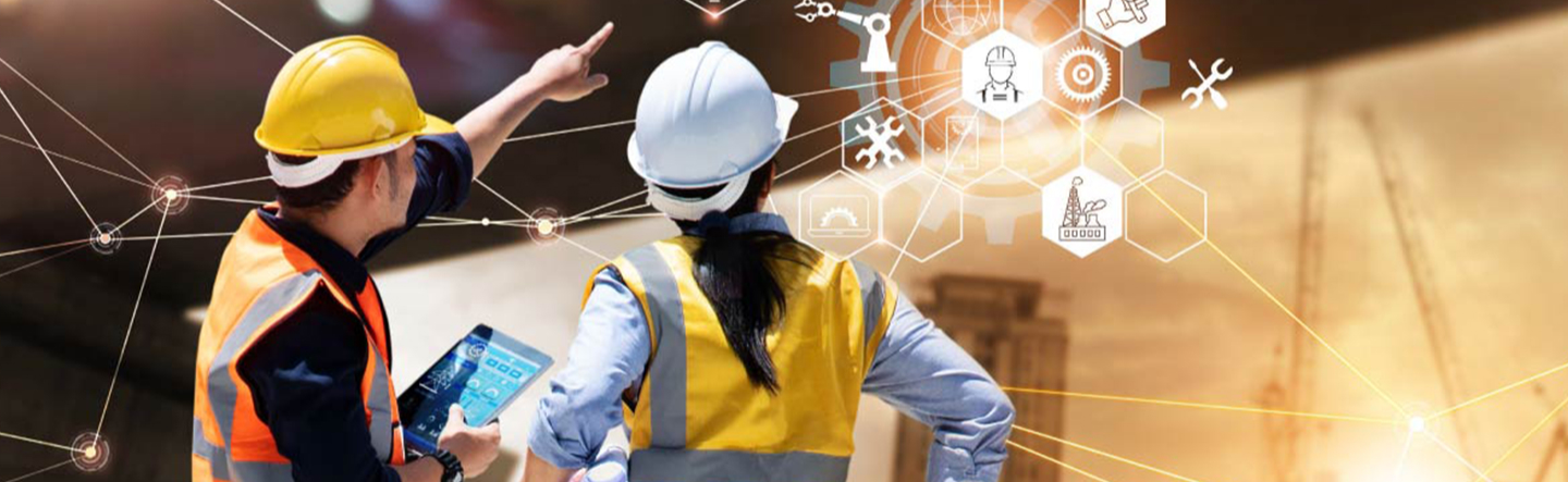 A worker in a hard hat using a tablet