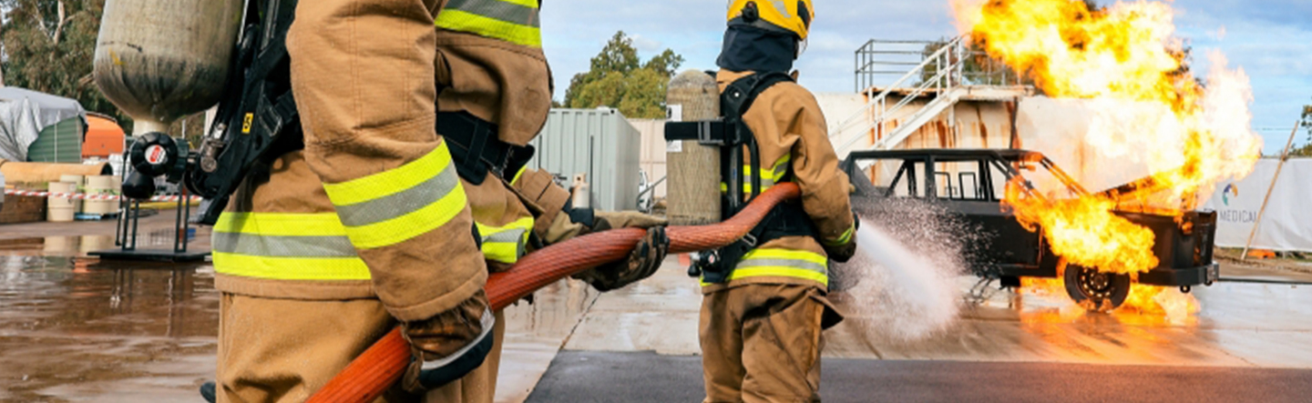 Firefighters spraying a hose