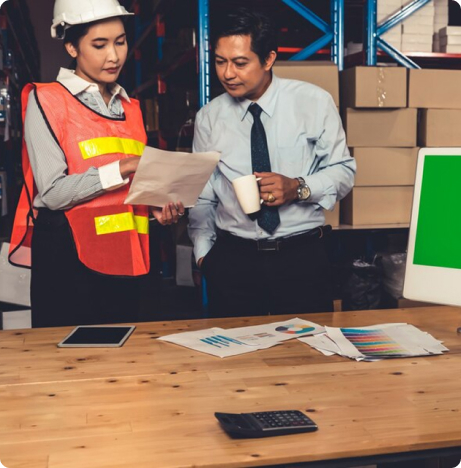 Warehouse staff checking paperwork among parcels
